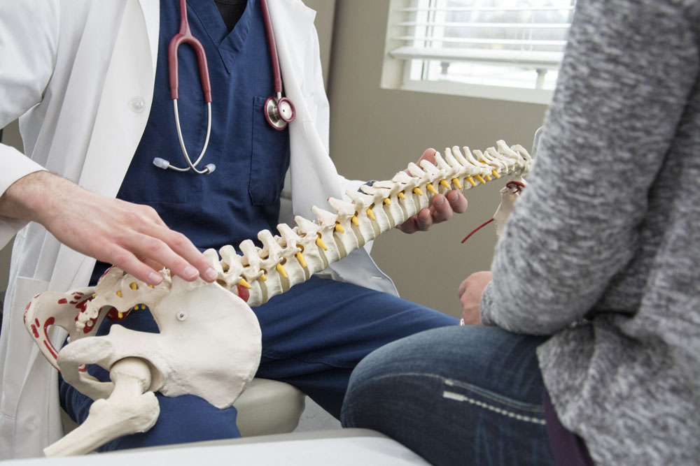 Doctor talking to his patient about spinal health.